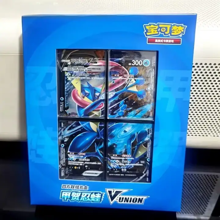 Physical blue Greninja V-UNION window box with four card sections and 甲贺忍蛙 lettering, including the original surrounding scene