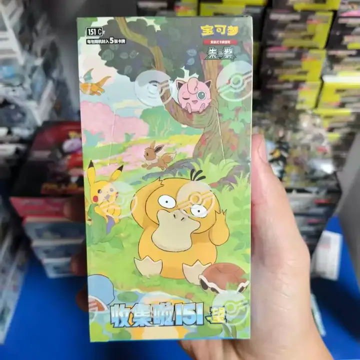 Hand holding a 151 Vol. 2 package with Psyduck and Pikachu artwork — CN-M035 Large-box catalog reference
