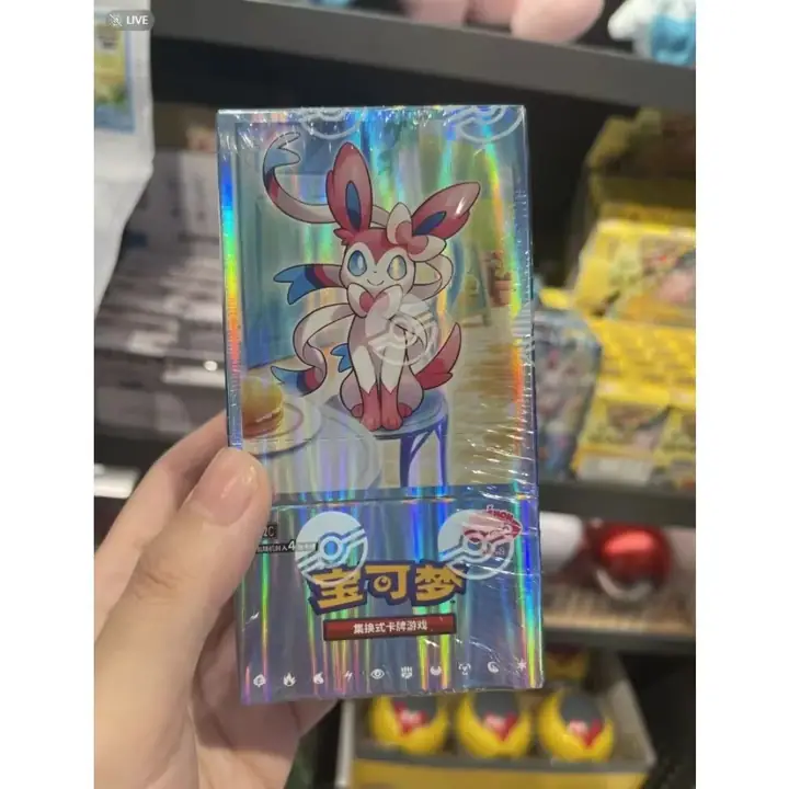Hand-held reflective Sylveon Gem Pack Vol.2 inner box; outer-carton correspondence for CN-M009 is unverified